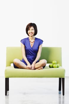 Portrait of a young woman sitting on a couch