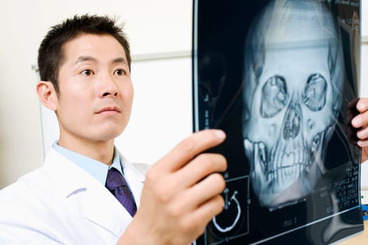 Close-up of a male doctor holding an X-Ray image