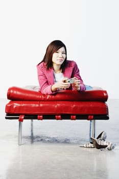 Portrait of a young woman holding a digital camera