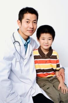 Portrait of a male doctor and a boy sitting together