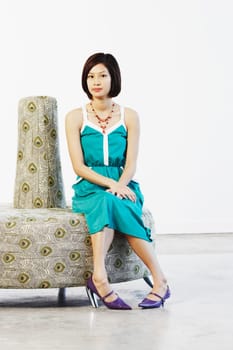 Portrait of a young woman sitting on a couch