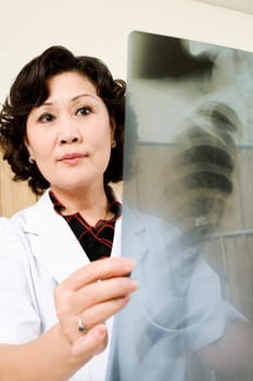 Close-up of a female doctor examining an X-Ray