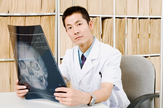 Portrait of a male doctor holding an X-Ray