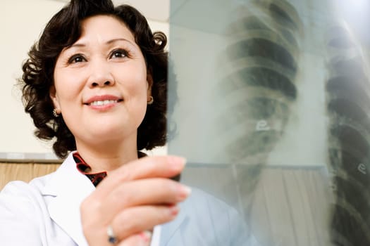 Close-up of a female doctor examining an X-Ray