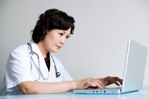 Close-up of a female doctor working on a laptop