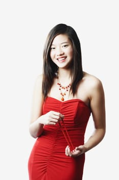 Portrait of a young woman holding chopsticks