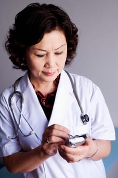Close-up of a female doctor holding a personal data assistant