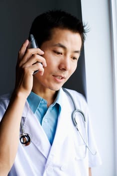 Close-up of a male doctor talking on a mobile phone