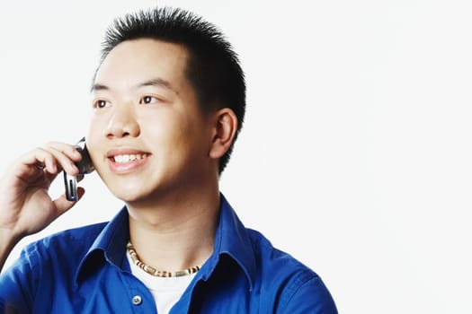 Close-up of a young man talking on a mobile phone