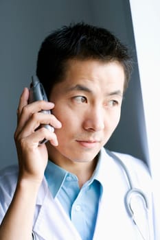 Close-up of a male doctor talking on a mobile phone