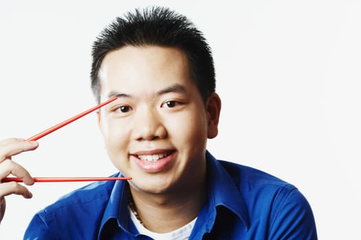 Portrait of a young man holding chopsticks
