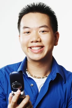 Portrait of a young man holding a mobile phone
