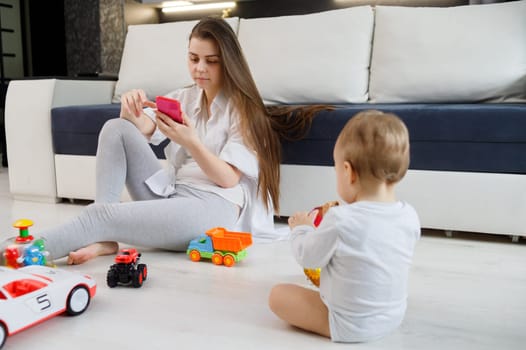 Young woman ignore her kid and looking at their mobile phones.