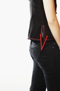 Mid section view of a young woman with chopsticks in her pockets