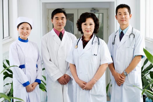 Portrait of three doctors and a nurse standing together