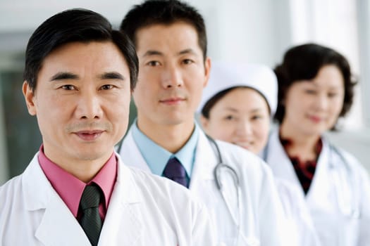 Portrait of three doctors with a nurse