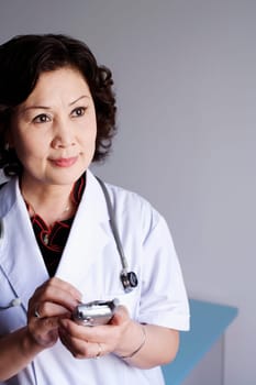 Close-up of a female doctor holding a personal data assistant