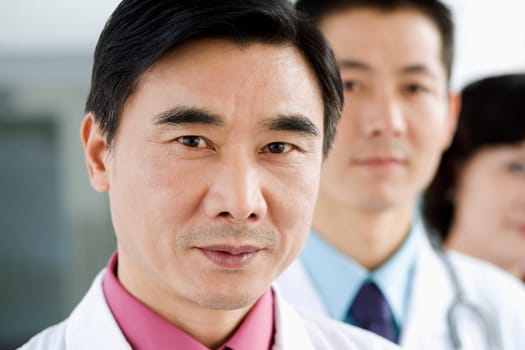 Portrait of two male doctors with a female doctor