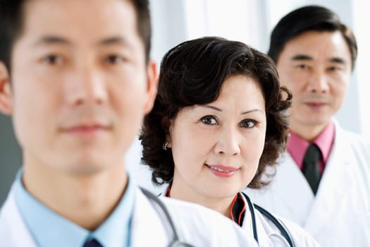 Portrait of two male doctors with a female doctor