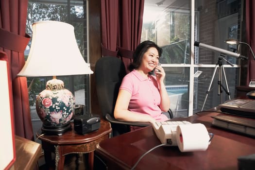 Mature woman talking on a cordless telephone