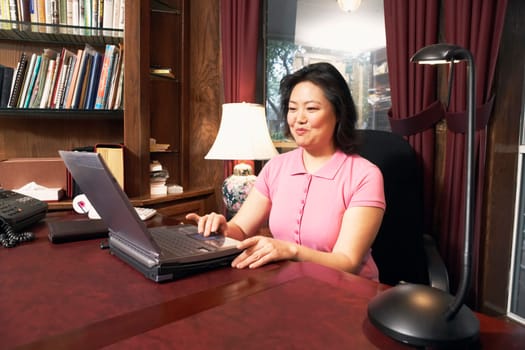 High angle view of a mature woman using a laptop