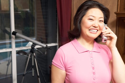 Portrait of a mature woman talking on a cordless telephone