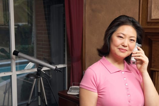 Portrait of a mature woman talking on a cordless telephone
