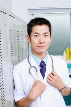 Portrait of a doctor standing and holding a stethoscope