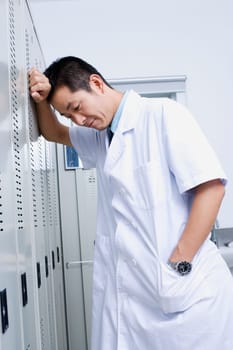 Close-up of a doctor leaning against a locker