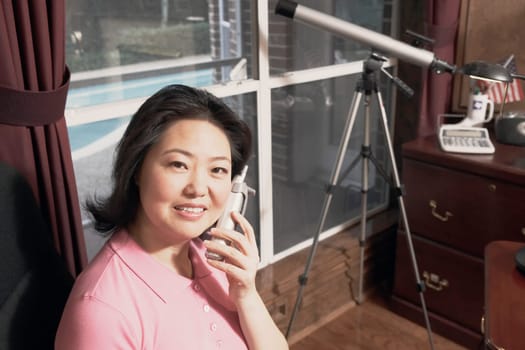 Portrait of a mature woman talking on a cordless telephone