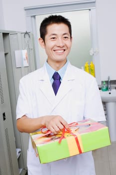 Close-up of a doctor holding a gift