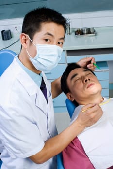 Portrait of a male doctor while examining a male patient