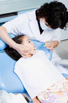 Close-up of a female dentist examining a girlŽs teeth