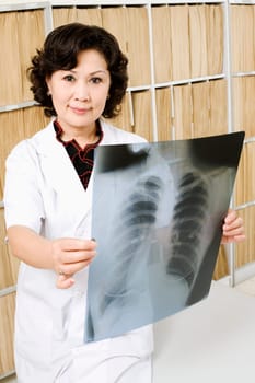 Portrait of a female doctor holding an X-Ray image