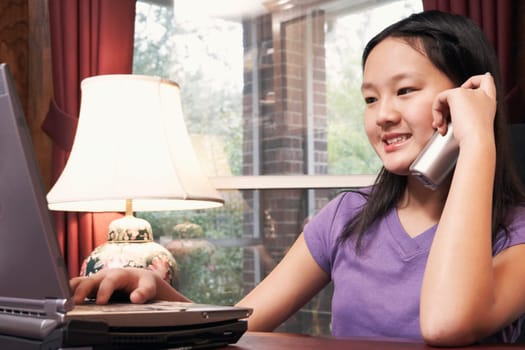 Close-up of a girl talking on a cordless telephone