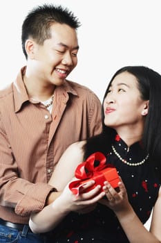 Close-up of a young couple holding a gift