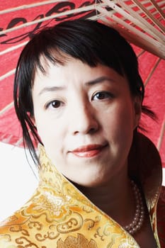 Portrait of a mid adult woman holding a parasol