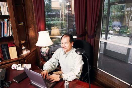 High angle view of a senior man using a laptop