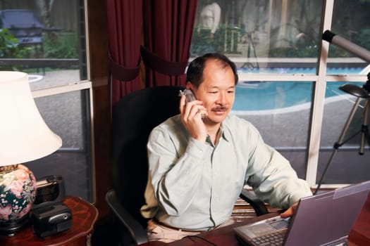 High angle view of a senior man talking on a cordless telephone