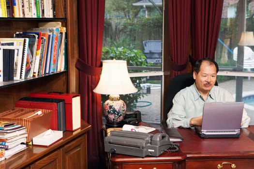 High angle view of a senior man using a laptop