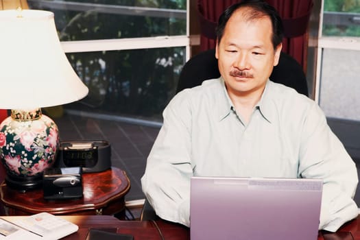 High angle view of a senior man using a laptop