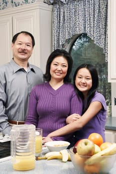 Portrait of a girl and her parents in the kitchen