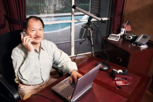 High angle view of a senior man talking on a cordless telephone