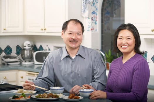 Portrait of a senior man smiling with a mature woman at the breakfast table