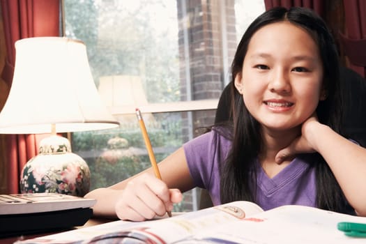 Portrait of a girl holding a pencil