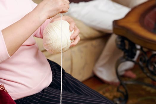 Mid section view of a senior woman holding a ball of wool