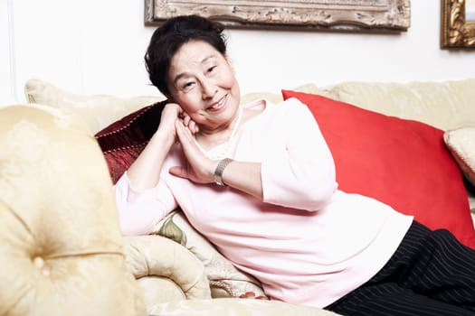Portrait of a senior woman sitting on a couch