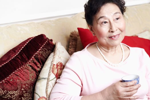 Close-up of a senior woman holding a tea cup
