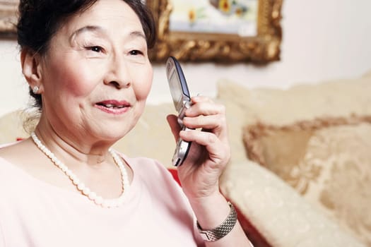 Close-up of a senior woman holding a mobile phone