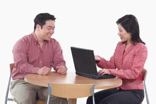 Close-up of a businesswoman and a businessman smiling